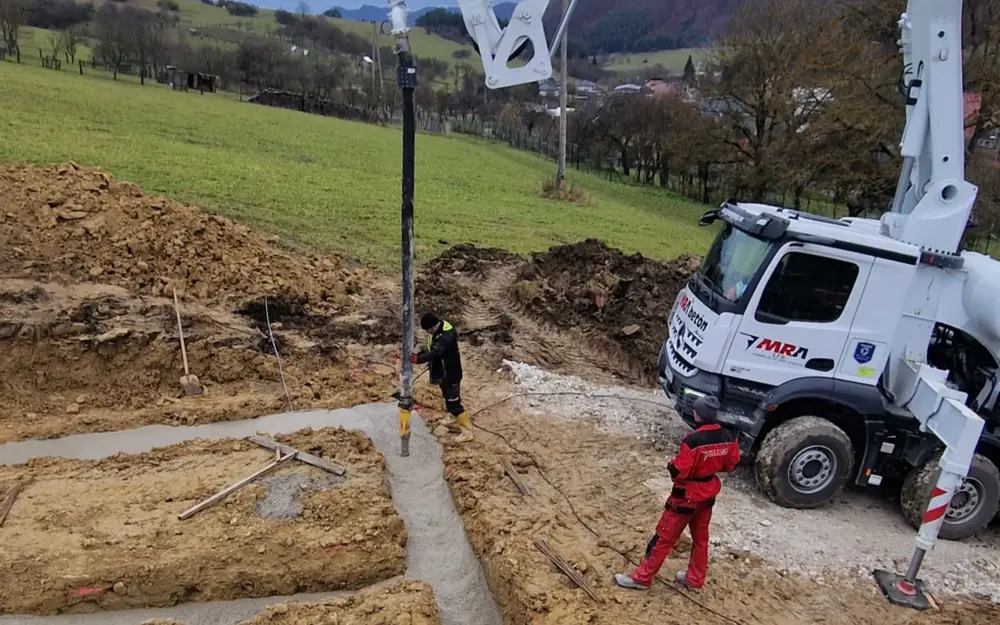 Concrete pump and the crew pouring foundations
